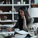 Woman writing in a notebook finding a career path that is perfect for her